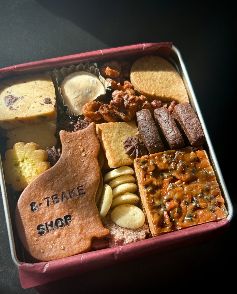 8・7 BAKE SHOPのクッキー缶(大)。
正方形の缶に、臙脂色の薄紙、お座りした猫のクッキーが可愛い。
ほかチョコチップクッキー、ラムボール、雫型のチャイのクッキー(ジンジャーだったかも)、間に詰められた胡桃のキャメリゼ、フロランタンなど。